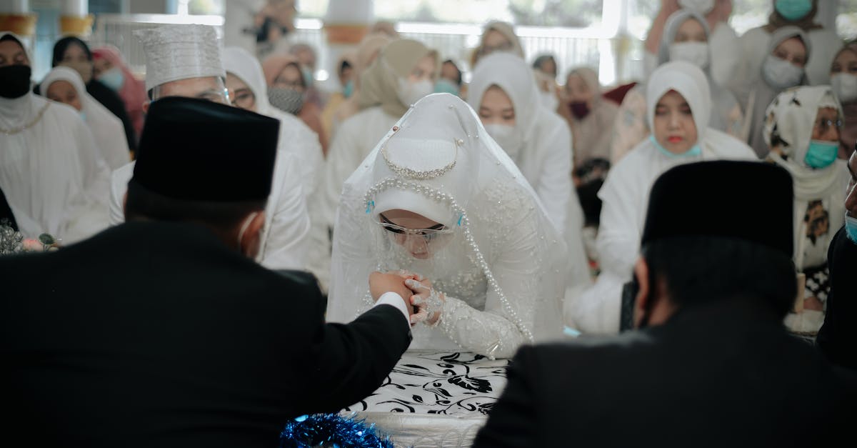 A bride in a traditional Islamic wedding ceremony, surrounded by family and friends, showcasing cultural attire and customs.